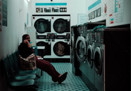 Wash Your Clothes, woman sitting inside laundry shop